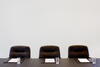 Boardroom chairs with paper and glasses